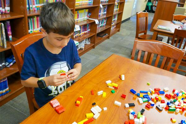 student with colorful blocks